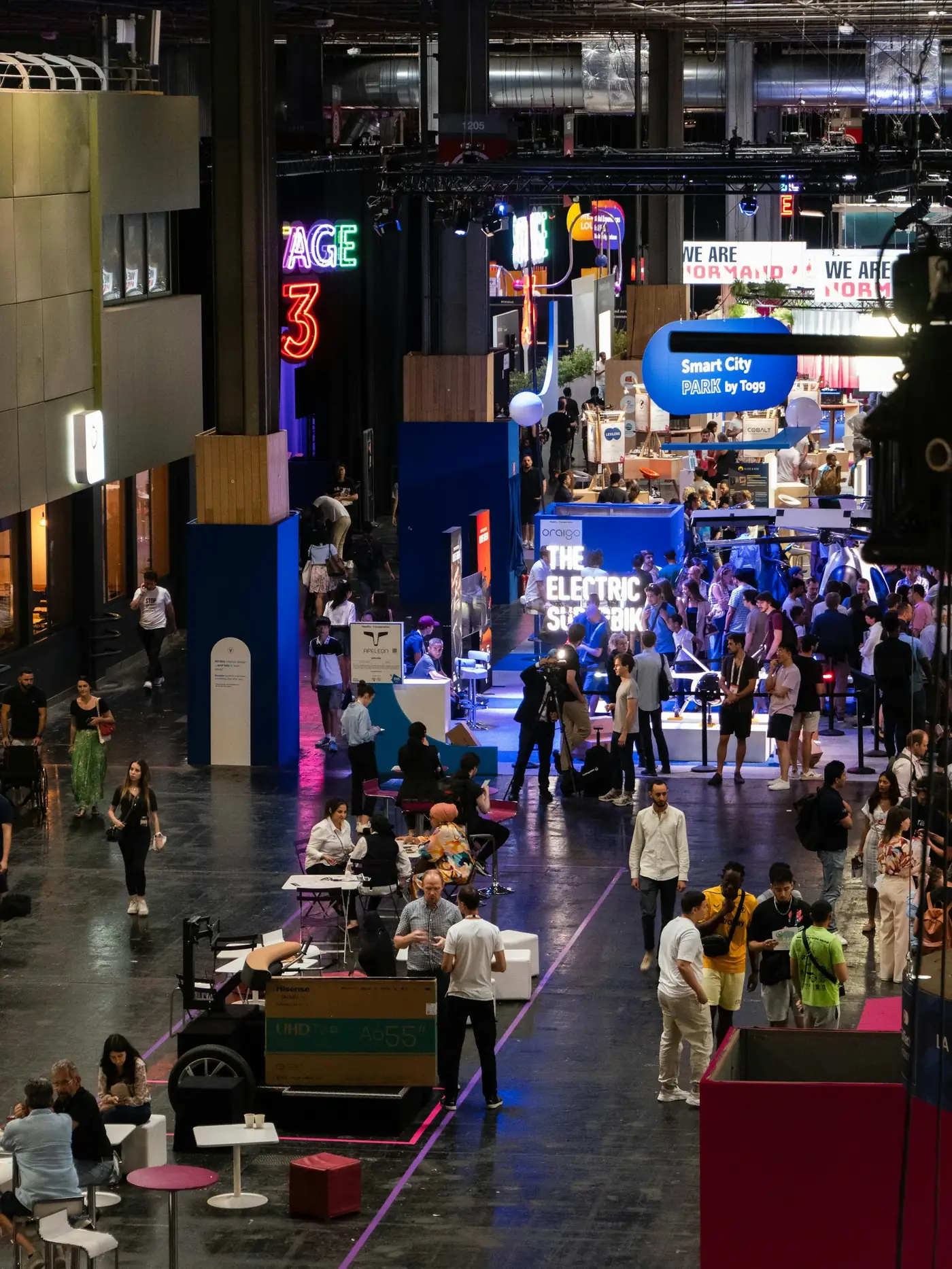 Attendees browsing exhibitor booths on a busy expo floor