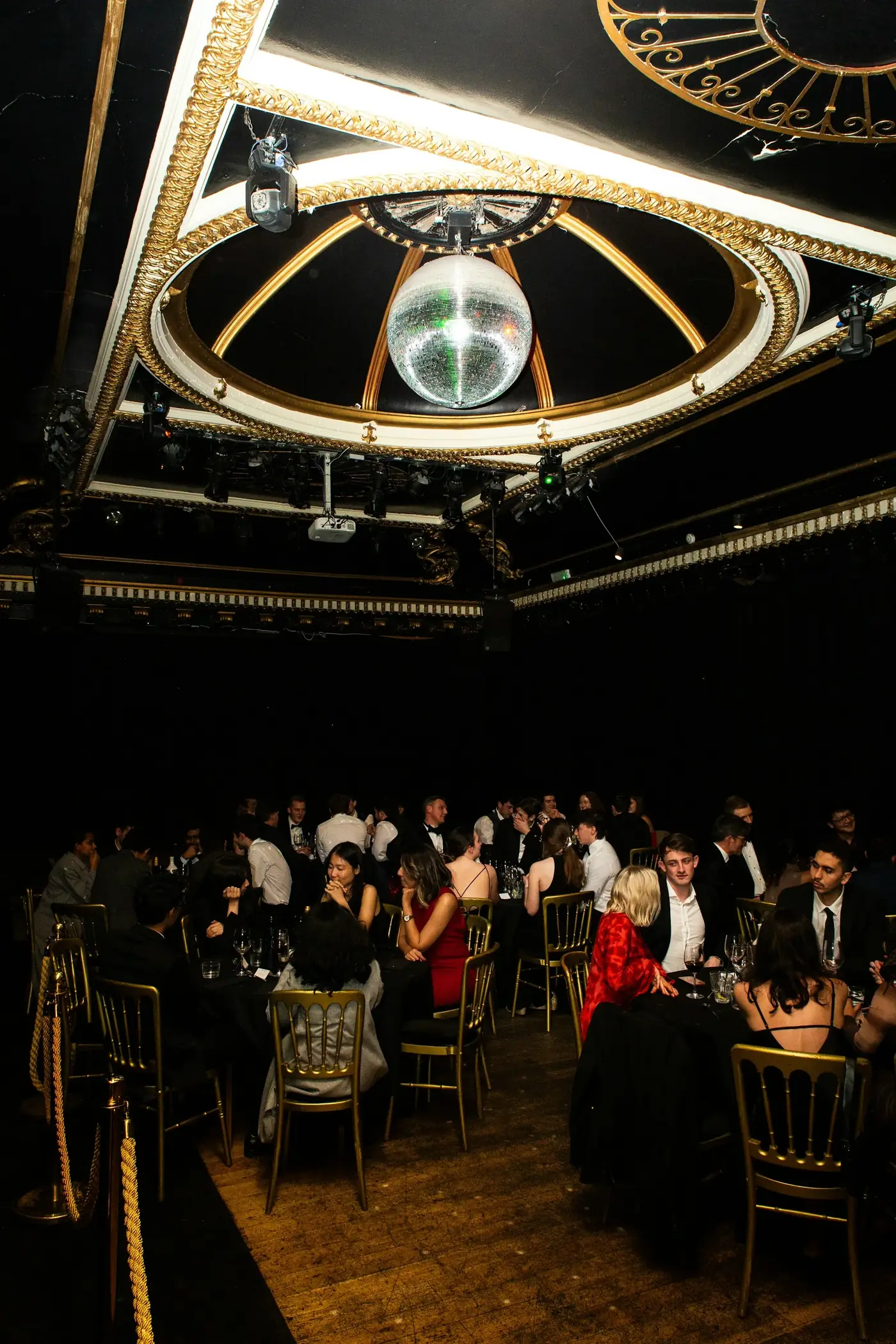 Guests in formal attire mingling at an elegant evening gala