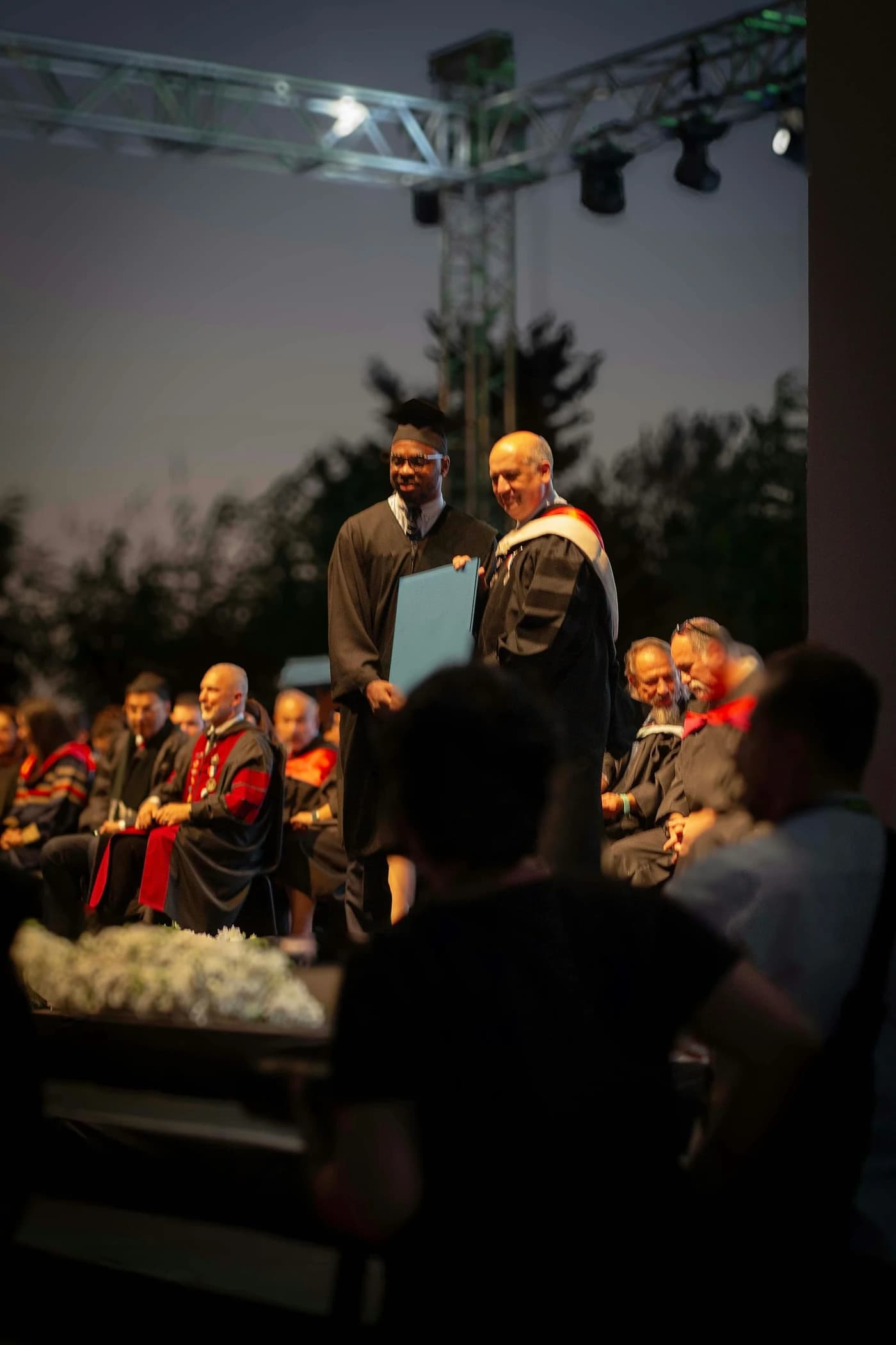 Graduates in caps and gowns celebrating at a commencement ceremony